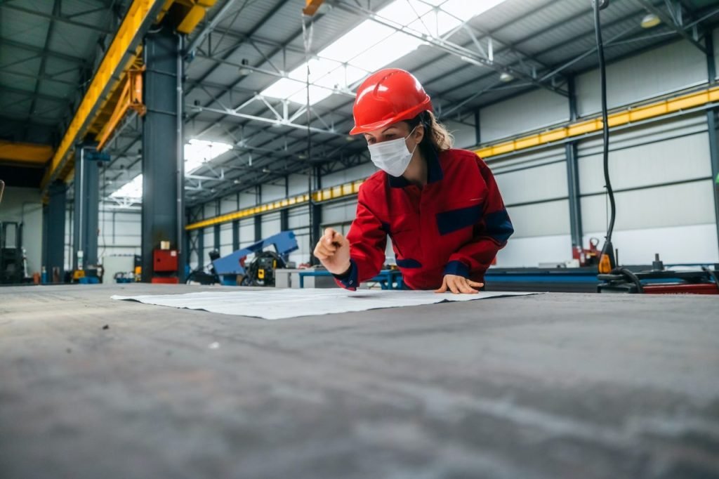 Engineer reviewing technical drawings in an industrial facility
