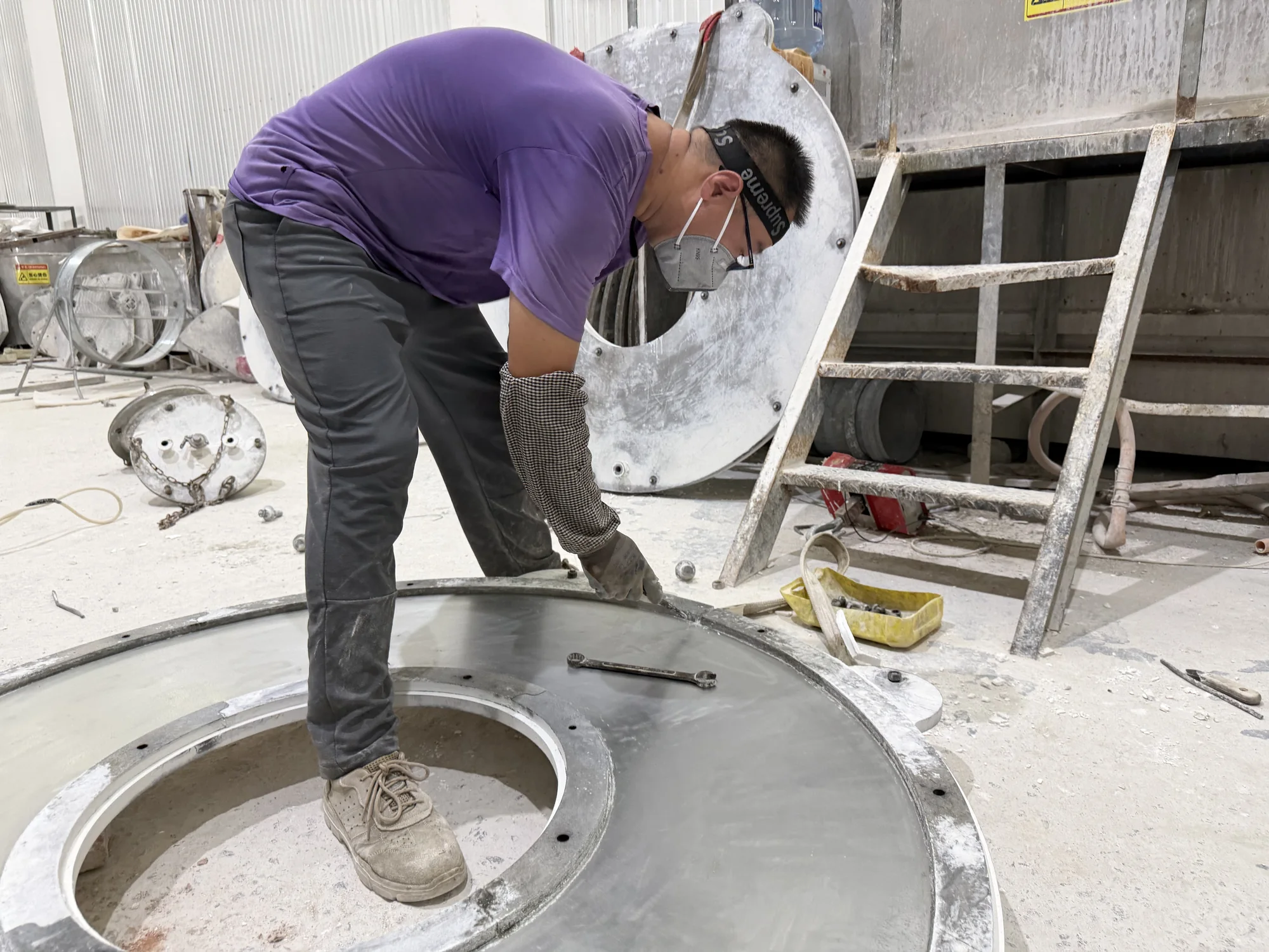 Worker machining a large technical ceramic component