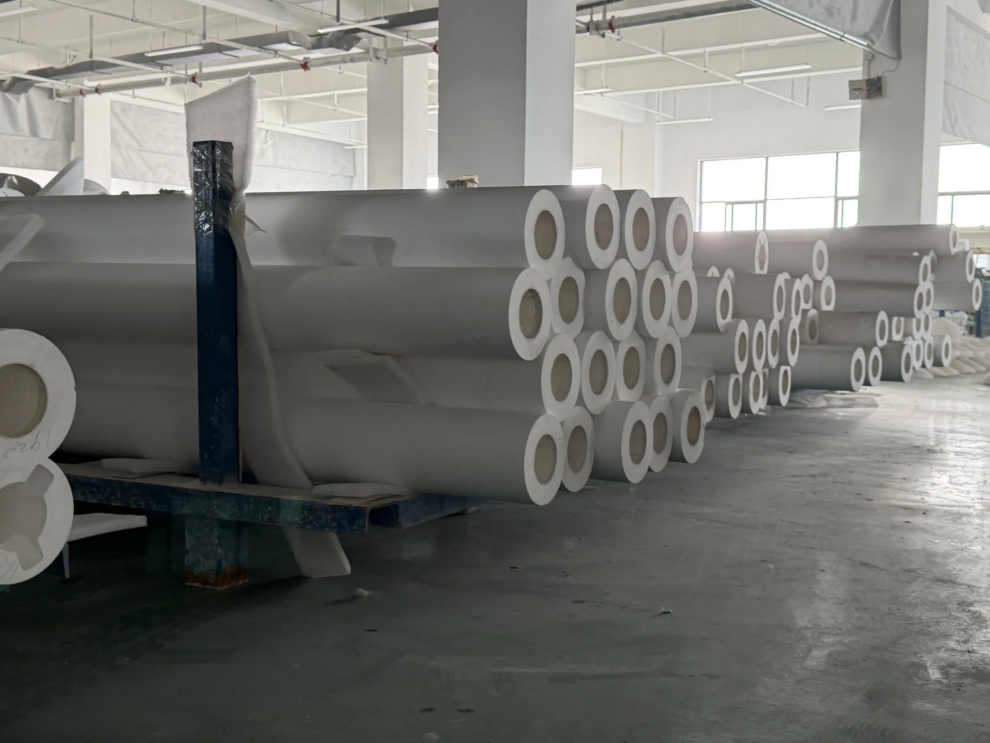 Large hollow ceramic tubes and rollers in the workshop
