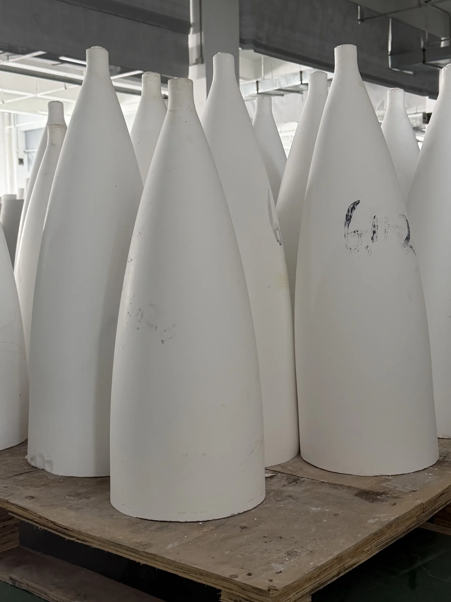 Large ceramic radome and nose-cone components photographed in the workshop