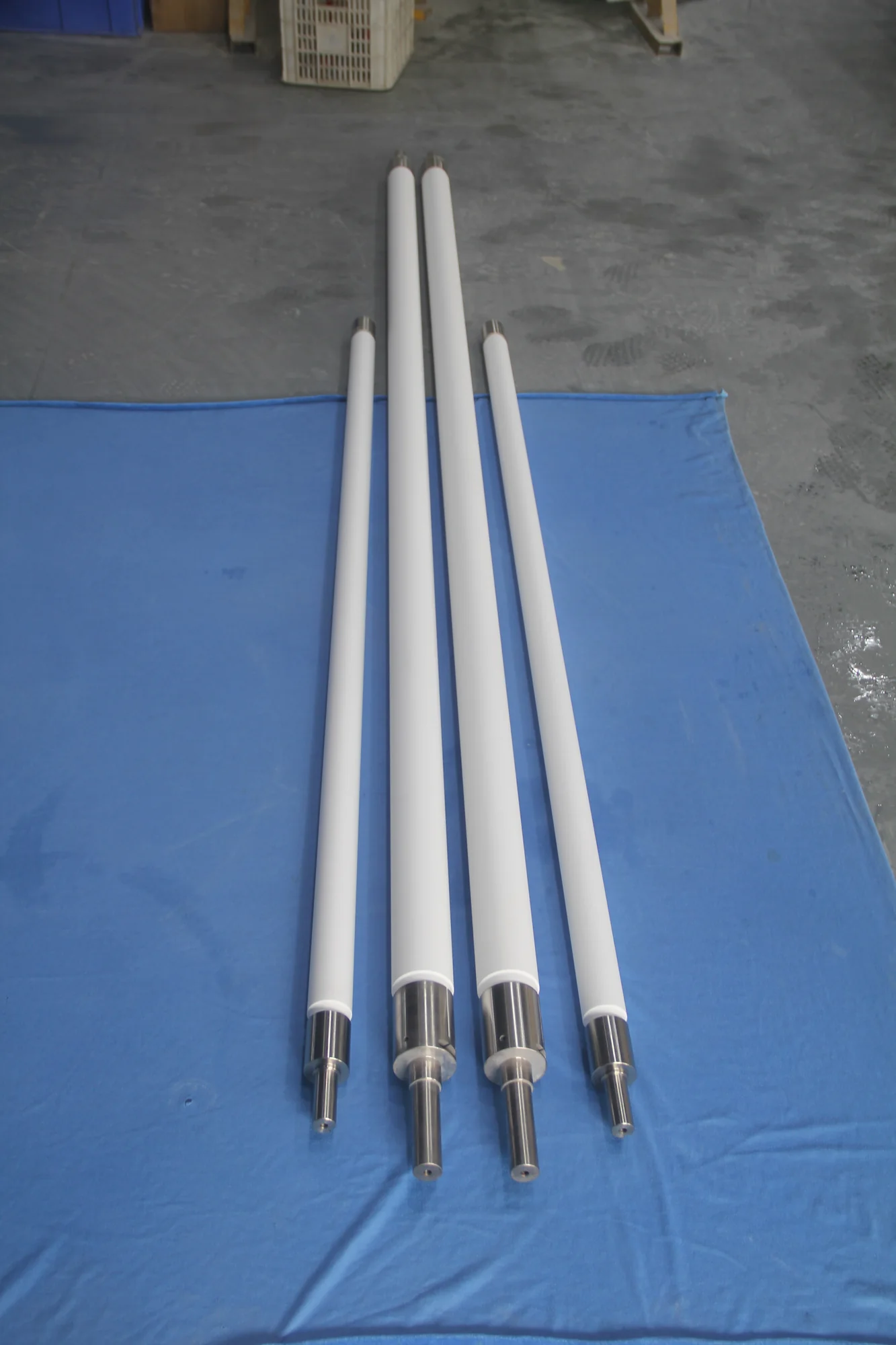 Long industrial ceramic rollers with metal end fittings